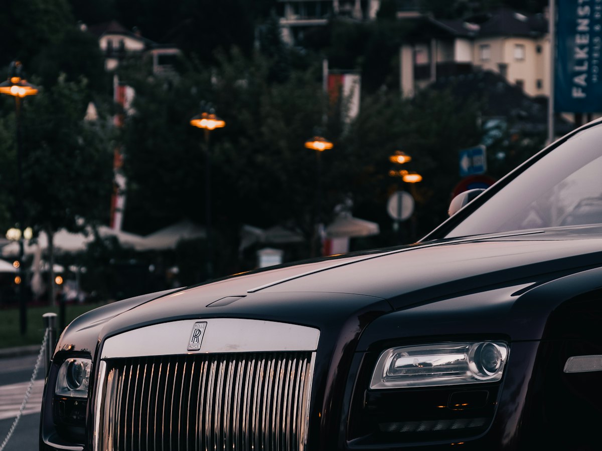 A black car parked at dusk